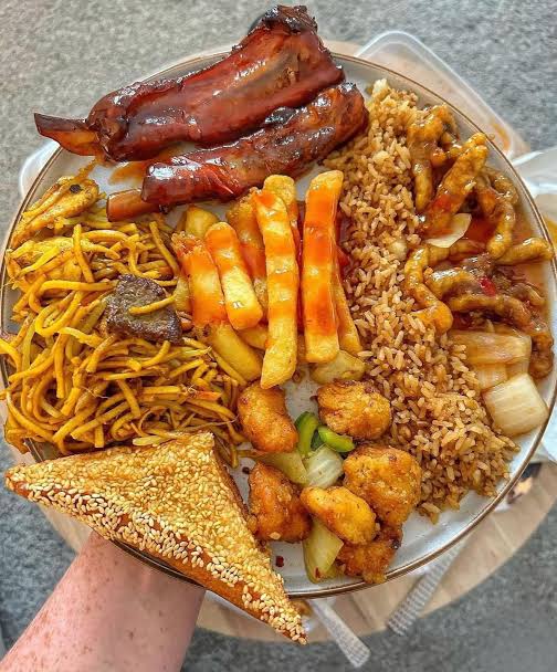 Sharing platter with spring rolls, sweet and sour chicken, ribs, chips and chow mein