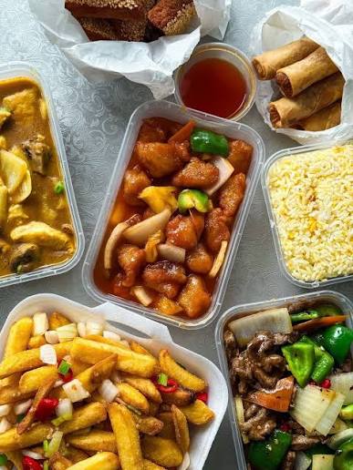 Jumbo takeaway containers of chicken curry, sweet and sour chicken, egg fried rice, salt and pepper chips and beef in black bean sauce